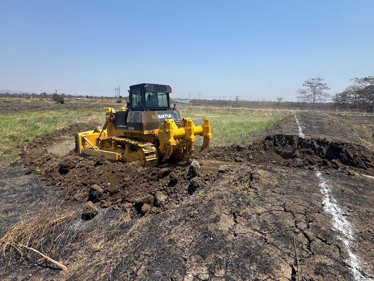 BMR bulldozer pushing earth across open land